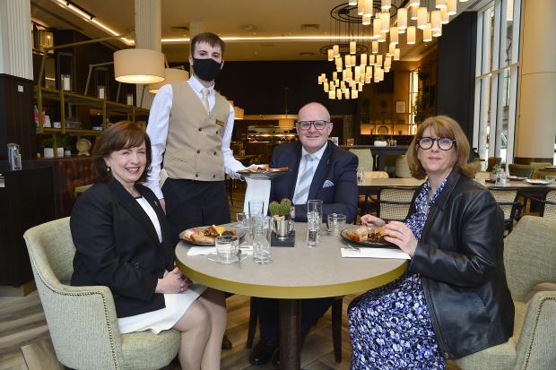 Diane Dodds; Stephen Meldrum, General Manager of the Grand Central; and Janice Gault, Chief Executive, NI Hotels Federation have their breakfast served to them in the Grand Central Hotel by Conor Sullivan