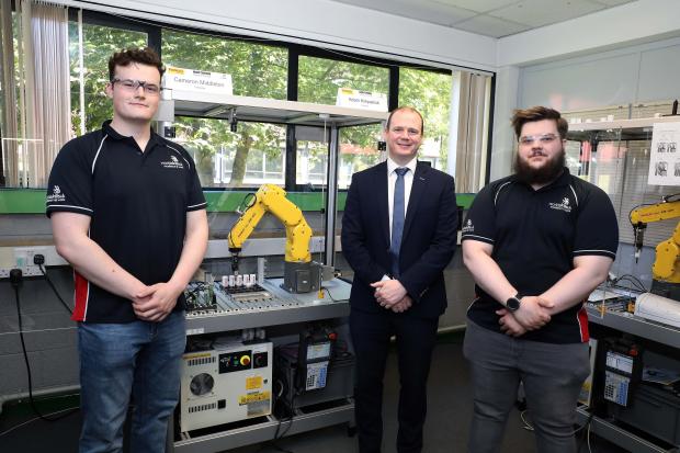 Pictured with the Minister during his visit to Northern Regional College's Ballymena campus are Adam Kirkpatrick and Cameron Middleton, members of the WorldSkills UK International Team in Industrial Robotics. 