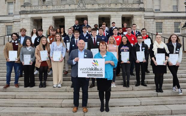 NI students who competed at the WorldSkills UK finals and as part of Team UK in the global WorldSkills Competition 2022 Special Edition pictured with Dr Neil Bentley-Gockmann OBE, CEO of WorldSkills UK, and Heather Cousins, DfE